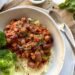 Ultimate Slow-Simmered Beans in Rich Tomato Sauce on a bed of mash potato with broccoli on the side